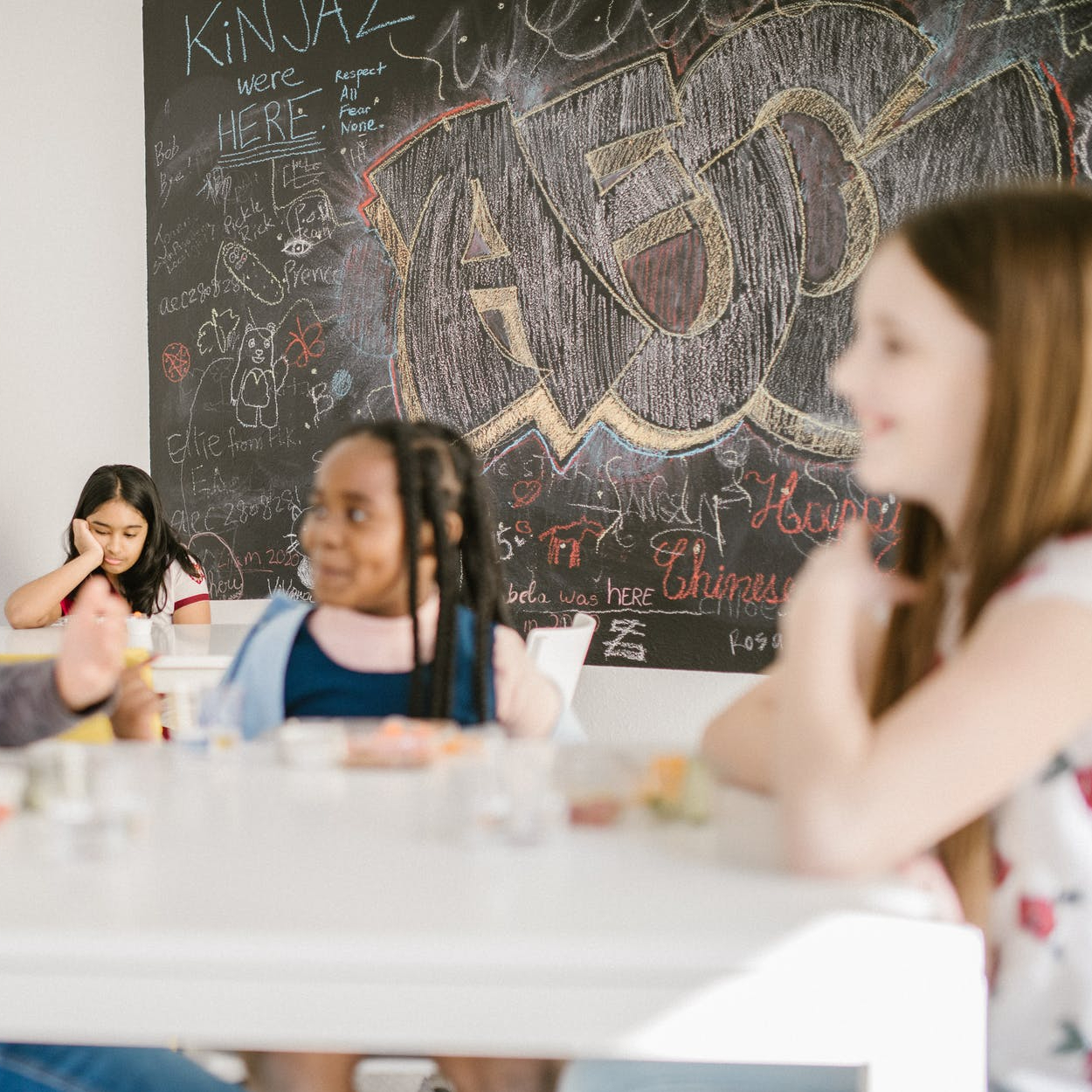 a girl sitting lonely by herself in the classroom