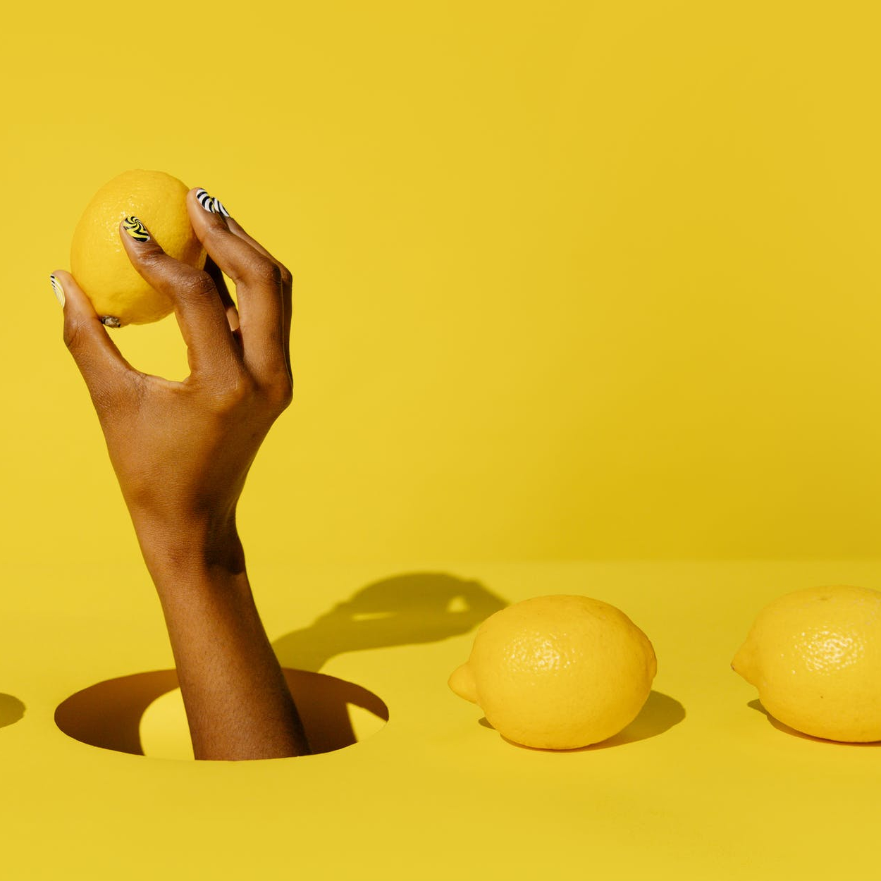 person holding yellow round fruit